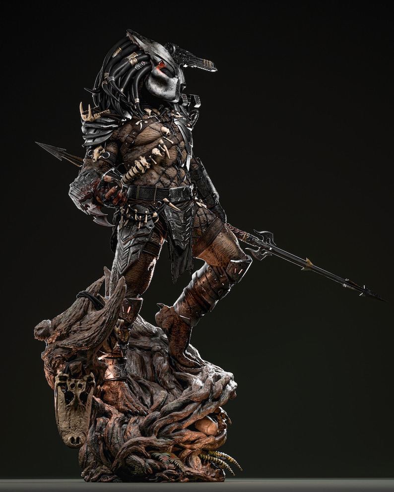 May include: A detailed statue of a Predator alien warrior, standing on a textured, organic base. The figure is clad in intricate armor with a mask, and holds a spear. The color palette includes shades of brown, black, and silver.