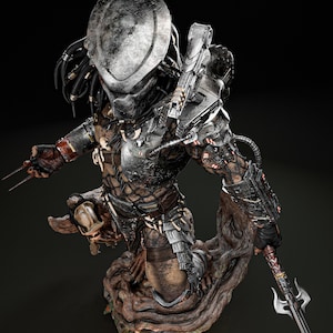 May include: A detailed statue of a Predator alien warrior, featuring a metallic helmet, armor, and weaponry. The figure is posed on a textured, wooden base, with intricate details and a dark color palette.