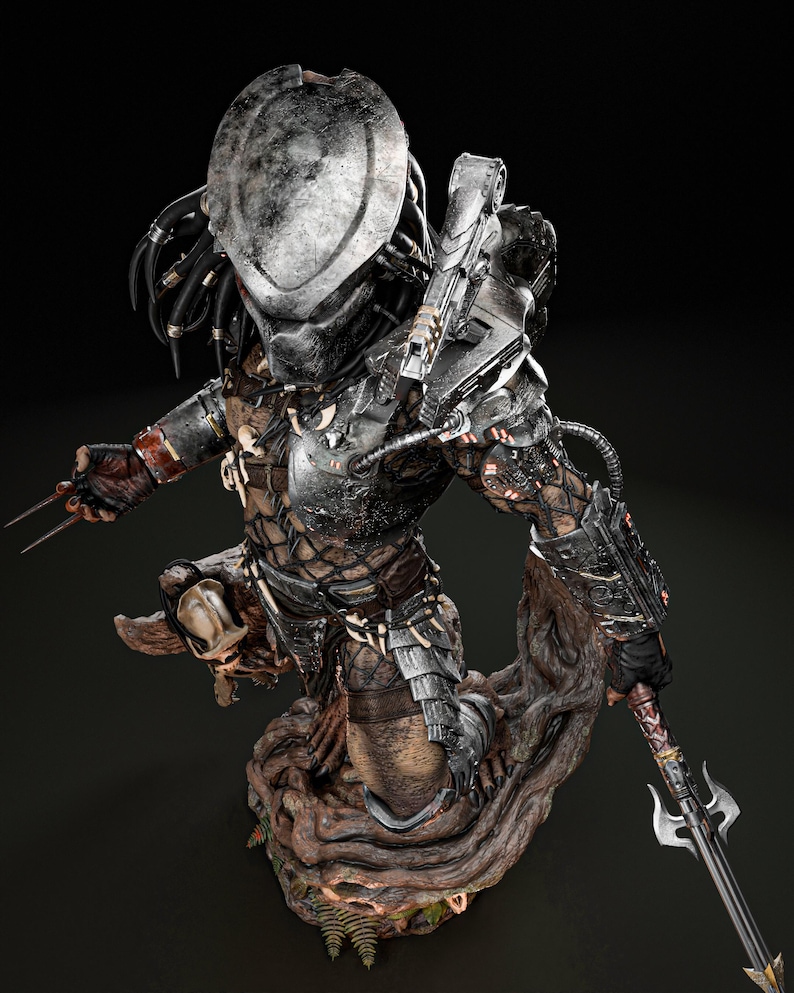 May include: A detailed statue of a Predator alien warrior, featuring a metallic helmet, armor, and weaponry. The figure is posed on a textured, wooden base, with intricate details and a dark color palette.
