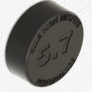 May include: A black, circular object with the text "MILE HIGH MISFITS" and "PERFORMANCE" around the edge. The number "5.7" is prominently displayed in the center. The object has a slightly beveled edge.