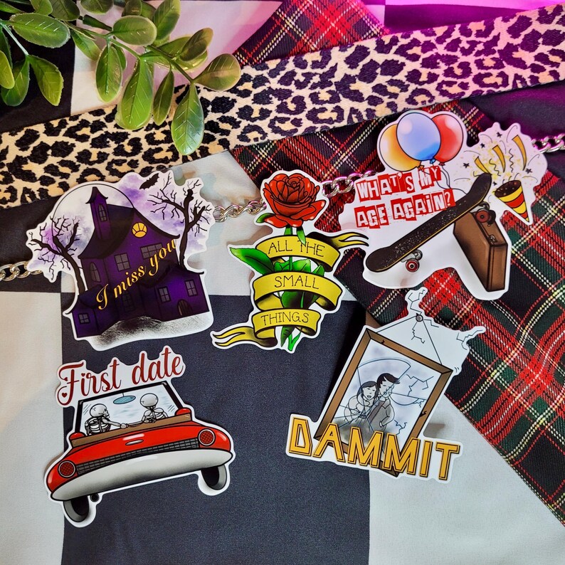 May include: A set of six colorful stickers featuring various designs, including a haunted house with the text "I miss you", a car with skeletons driving with the text "First date", a rose with the text "All the small things", a skateboard with the text "What's my age again?", a framed picture with the text "Dammit", and a heart with the text "Love you".