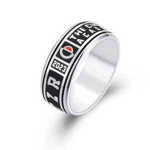 May include: A silver ring with a black band featuring the text "THE CITY ACADEMY" and the year "2023".