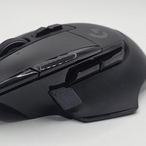 May include: Black wireless gaming mouse with multiple buttons and a scroll wheel. The mouse has a textured side grip and the Logitech logo. The mouse has buttons labeled G5 and G4.