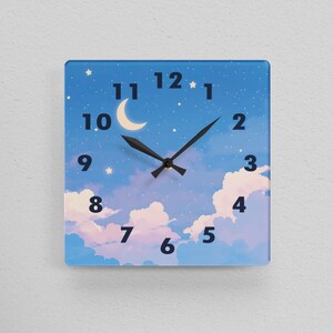 May include: Square wall clock with a blue sky and cloud design, featuring a crescent moon and stars. The clock face has black hands and black numerals. The clock is hanging on a white wall.