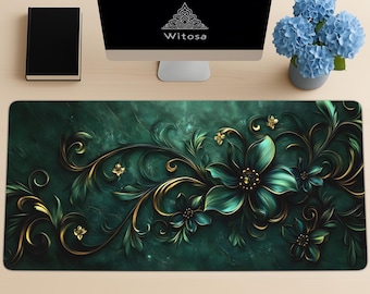 May include: A decorative emerald green desk mat with a floral design featuring teal and gold accents. The mat has a dark green marble-like background and the word "Witosa" is displayed on the computer screen.