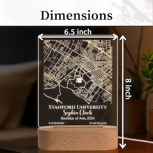 May include: A personalized LED map of Stanford University, 6.5 x 8 inches, with the name Sophia Clark and Bachelor of Arts degree details. The map is etched on a clear acrylic panel, illuminated by a wooden base. The dimensions are indicated on the image.