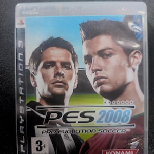 May include: A PlayStation 3 game case for PES 2008: Pro Evolution Soccer. The cover features two soccer players in a green and blue background. The game's title and logo are prominently displayed.