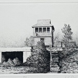 May include: Black and white etching print of a building with a watchtower, stairs, and surrounding trees. The print is on white paper with the title "Switching Station" and the artist's signature.