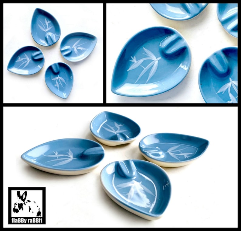 May include: Set of eight blue and white ceramic leaf-shaped ashtrays with a white floral design.