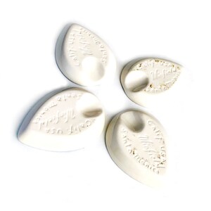May include: Four white ceramic leaf-shaped dish soap holders with the text "Cultured Products" and "Winfield" on them.