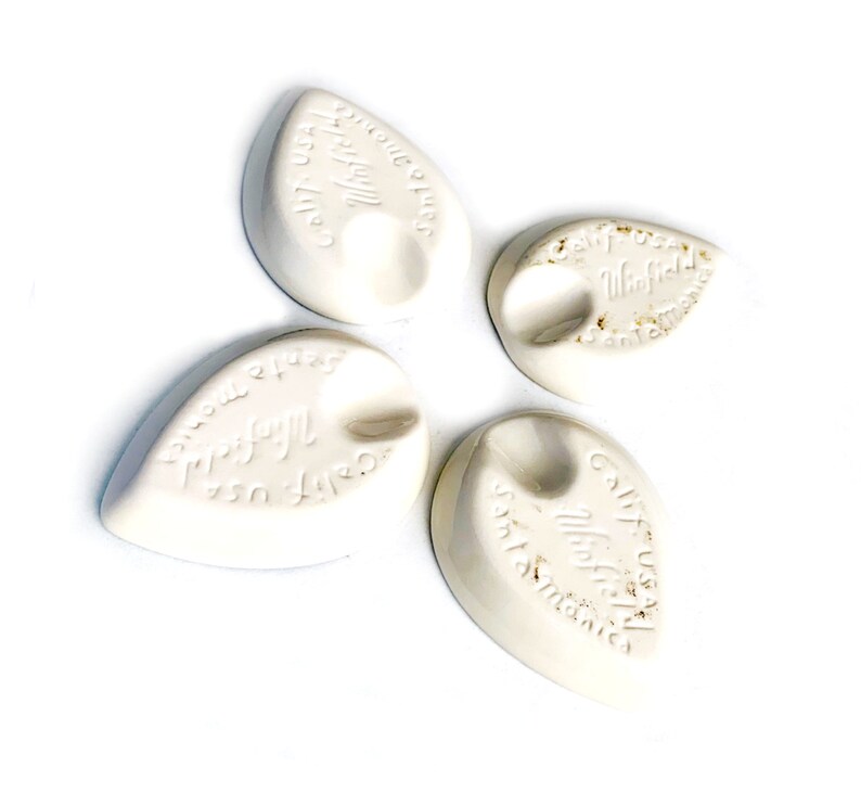 May include: Four white ceramic leaf-shaped dish soap holders with the text "Cultured Products" and "Winfield" on them.