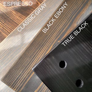 May include: Four wood samples stained in different colors: Espresso, Classic Gray, Black Ebony, and True Black. The wood grain is visible in each sample.