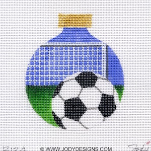 May include: A blue and green Christmas ornament with a soccer ball and a goal net. The ornament has a gold top.