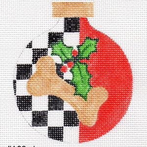 May include: A red and white checkered Christmas ornament with a bone and holly design. The ornament has a gold top and the text #A26-cks and www.jodydesigns.com.