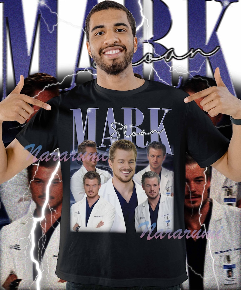 May include: Black t-shirt featuring a collage of images of Mark Sloan, with the name "Mark Sloan" in a purple font. The shirt has a vintage, retro design with a lightning bolt background.