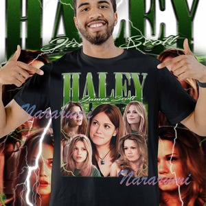 May include: Black t-shirt featuring the name "Haley" in green block letters with "James Scott" below. The shirt has a collage of images of a woman. The background has green lightning bolts and the word "Haley" in a stylized font.