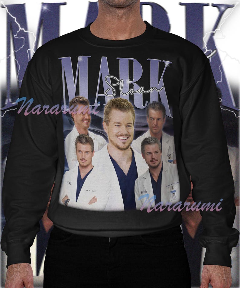 May include: Black sweatshirt featuring a collage of images and the name "MARK Sloan" in a purple retro font. The sweatshirt has a crew neck and long sleeves. The word "Nararumi" is printed on the bottom right.