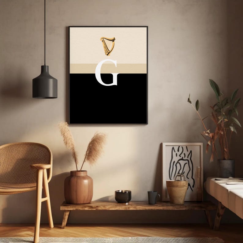 Minimalist art print inspired by Guinness branding, featuring a large letter G in black and cream tones, styled in a modern interior setting