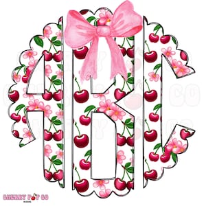May include: A circular monogram design featuring the letters ABK, filled with a pattern of cherries and pink flowers on a white background. A pink bow is at the top. The design has a scalloped edge and the text "CHERRY POP CO DESIGNS" at the bottom.