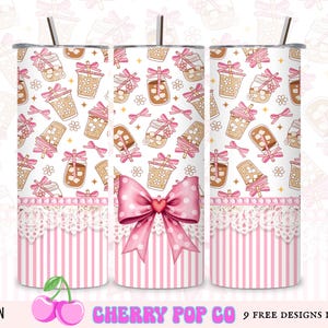 May include: A set of three stainless steel tumblers with a white background, adorned with a repeating pattern of iced drinks, bows, and flowers. The bottom section features pink stripes and lace trim, with a large pink bow. The text "CHERRY POP CO" is visible.