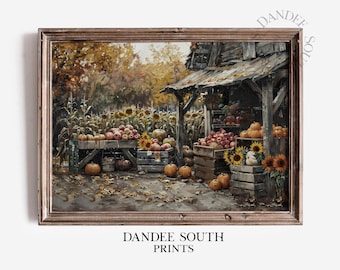 May include: A framed print depicting a rustic autumn scene. Wooden crates overflow with pumpkins, apples, and sunflowers. A weathered wooden structure stands amidst a field of corn and sunflowers, with fallen leaves scattered on the ground. The text "DANDEE SOUTH PRINTS" is visible.