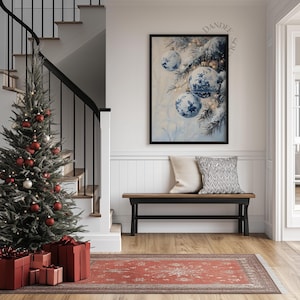 May include: A festive interior scene featuring a decorated Christmas tree with red ornaments and wrapped gifts. A framed artwork with blue and white Christmas ornaments hangs above a bench with pillows. A red rug adds warmth to the space.