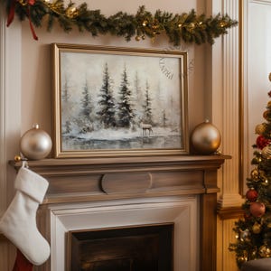 May include: A framed landscape painting of a forest scene with a deer, displayed on a mantelpiece. The painting has a gold frame and is surrounded by Christmas decorations, including ornaments, a stocking, and a garland.
