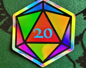May include: A holographic iridescent 20-sided die with a rainbow color scheme. The die is shaped like a dodecahedron and has a black outline.