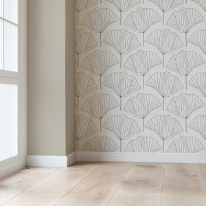 May include: Wallpaper featuring a repeating pattern of black line-drawn ginkgo leaves on a white background. The design covers the wall surface, showing a series of fan-shaped botanical motifs arranged in a grid-like layout across the wall.