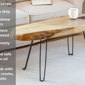 Solid wood couch table with live edge design, featuring waxed finish and industrial-style metal legs, ideal as a low-profile sofa side table.