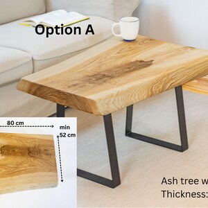 Unique rustic coffee table crafted from solid ash wood with preserved live edge and 5 cm thick top. Natural character with knots, cracks, and wood grain variations, finished in Osmo TopOil. Perfect for cozy interiors.