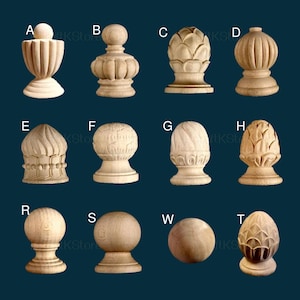 May include: A collection of wooden finials in various shapes, including urns, spheres, and stylized floral designs. The finials are displayed against a dark blue background, showcasing their natural wood grain and intricate carvings. The image includes letters A through T and W, likely for product identification.