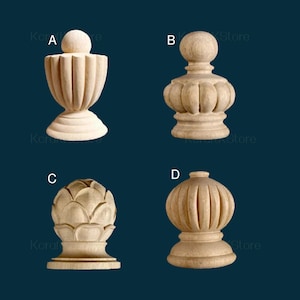 May include: Four unfinished wooden decorative finials in various shapes. The finials are light brown and include designs such as a vase, a bulbous shape, a pine cone, and a ribbed sphere. These are likely for furniture or architectural accents.