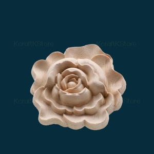 May include: A carved wooden rose with a detailed design. The rose is light brown and has a natural wood finish.