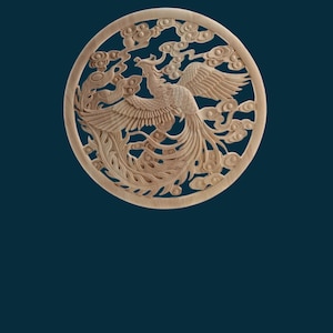 May include: A circular wooden carving of a phoenix with intricate details, surrounded by clouds. The carving is light brown in colour and has a smooth finish.