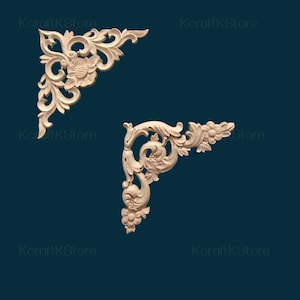 May include: Two wooden corner ornaments with floral and scroll designs. The carvings feature detailed leaves, flowers, and swirling patterns. The ornaments are unfinished, showing the natural wood grain, and are set against a dark teal background.