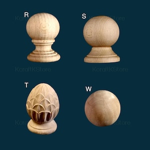 May include: Four wooden furniture finials in various designs. The finials are made of light-colored wood and include a ball shape, a decorative acorn shape, and a turned design. The background is a dark teal color.