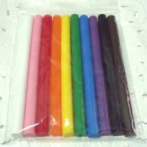 Peut inclure: Un paquet de dix bâtonnets de colle de différentes couleurs, dont blanc, rose, rouge, orange, jaune, vert, bleu, violet et noir.