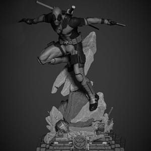 May include: A black and white statue of Deadpool in a dynamic pose, poised on a rocky base. The figure is clad in a detailed costume, holding swords and a gun. The base features intricate mechanical details and a circular emblem.