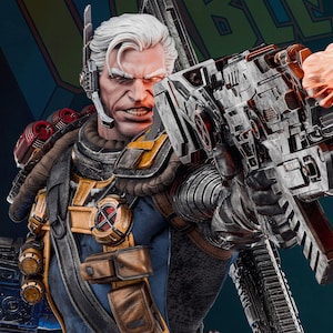 May include: A detailed statue of Cable, a comic book character, with white hair and a stern expression. He is wearing a blue and gold uniform with pouches and a large weapon. The background has the word "CABLE".