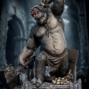 May include: A detailed statue from The Lord of the Rings depicting a large, grey troll with a spiked club. An elf with a bow stands on the troll's shoulder. The base includes skulls and the series logo.
