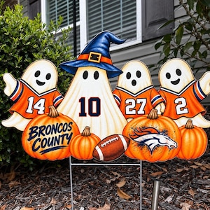 May include: A garden sign featuring four white ghosts wearing orange and blue jerseys with the numbers 14, 10, 27, and 2. The central ghost wears a blue witch hat. Three orange pumpkins, a football, and the text BRONCOS COUNTY are displayed.