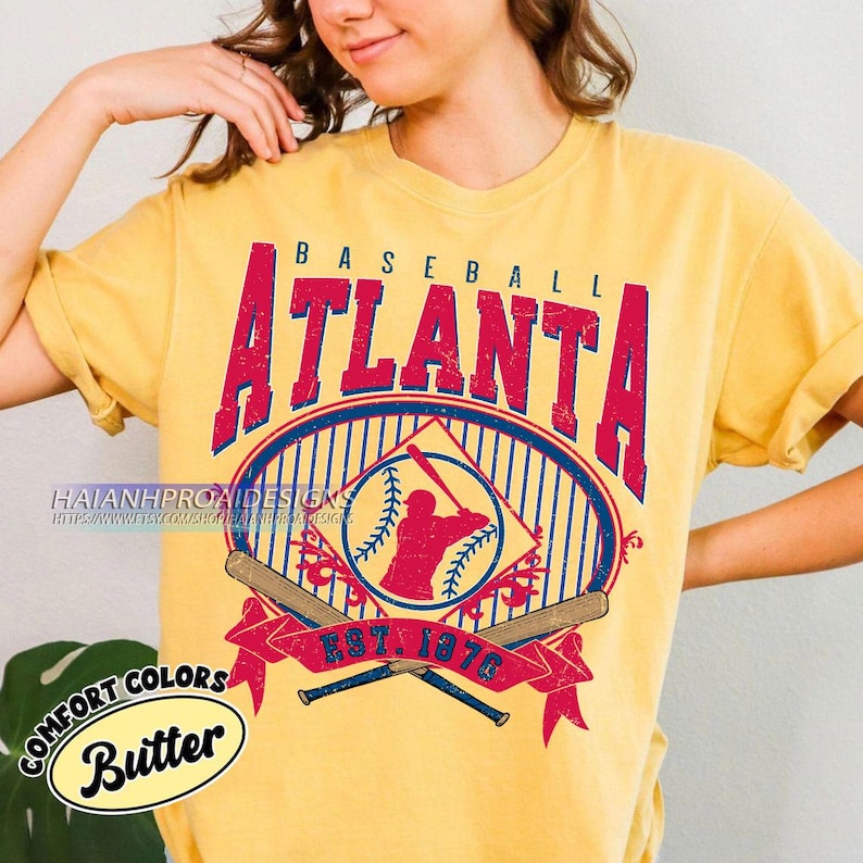 May include: A yellow t-shirt with a vintage baseball graphic featuring the text "BASEBALL ATLANTA EST. 1876" and a silhouette of a baseball player. The graphic is in red, blue, and white.