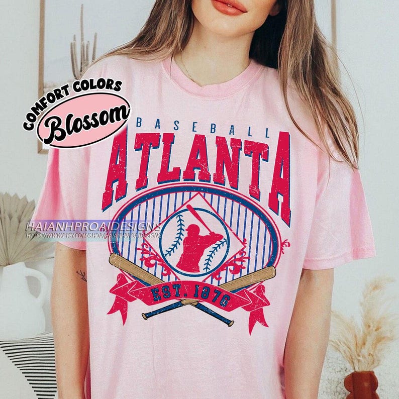 May include: Pink t-shirt with a vintage baseball graphic featuring the text "Baseball Atlanta Est. 1976" and a silhouette of a baseball player. The graphic is in red, blue, and white.
