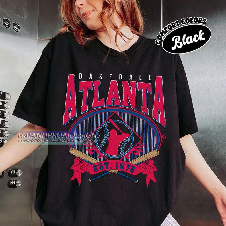 May include: Black t-shirt with a vintage baseball graphic featuring the text "BASEBALL ATLANTA EST. 1976" and a silhouette of a baseball player. The graphic is in red, blue, and white with a distressed look.