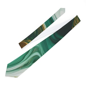 May include: A necktie with a green and white marbled pattern. The tie has a white backing and a dark green and gold pattern on the front. The tie is angled across a white surface.