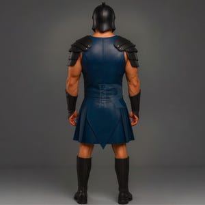 May include: A blue and black gladiator costume. The costume includes a helmet, shoulder armor, a sleeveless tunic, a pleated skirt, arm cuffs, and knee-high boots. The costume is made of leather-like material.