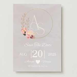 Puede incluir: Una tarjeta de guardar la fecha con un fondo de acuarela en tonos de morado y rosa. La tarjeta presenta una corona floral con un círculo dorado y las iniciales "A" y "S" en blanco. El texto "Save The Date" está en letra blanca de estilo cursivo. La fecha "AUG | 20 | 2025" está en letra blanca de estilo sans-serif. Los nombres "Aarya" y "Khaan" están en letra blanca de estilo cursivo con un símbolo de corazón entre ellos. La dirección "123 Anyaburo St. Any City" está en letra blanca de estilo sans-serif.
