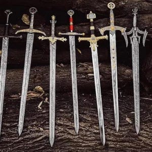 May include: Six decorative swords with silver blades and detailed hilts are displayed against a dark wood background. The swords vary in design, with some featuring gold accents and intricate crossguards. The blades have a textured pattern.