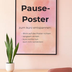 May include: A framed poster with the words "Pause-Poster" in large black letters. The poster has a pink and orange watercolor background and includes instructions in German for relaxation: "Look at the poster, breathe slowly, do nothing (don't even think)."